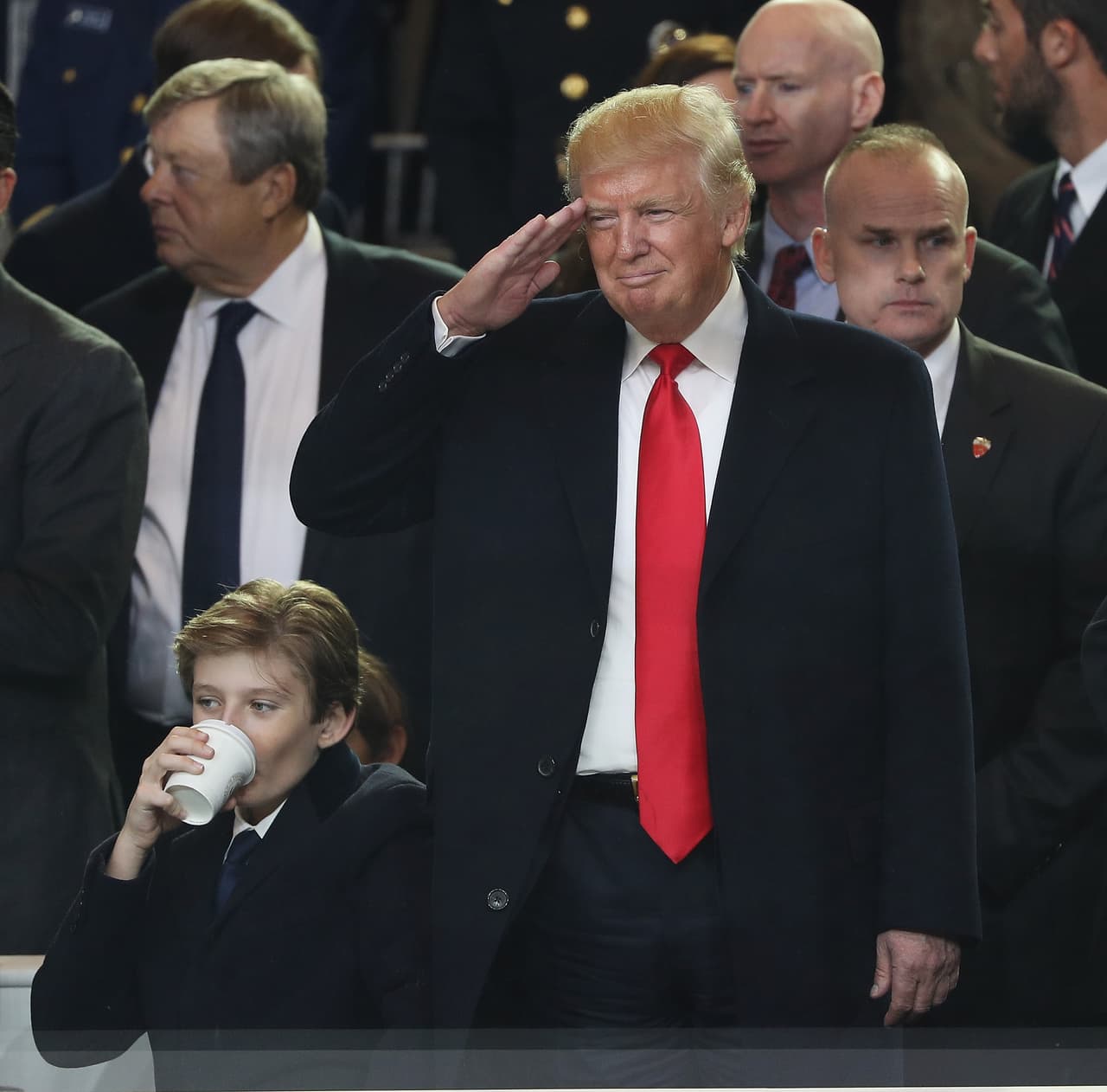 WASHINGTON, DC - JANUARY 20: U.S. President Donald Trump salutes as he and Barron Trump watch the Inaugural Parade from the main reviewing stand in front of the White House on January 20, 2017 in Washington, DC. Donald J. Trump was sworn in today as the 45th president of the United States. (Photo by Patrick Smith/Getty Images)