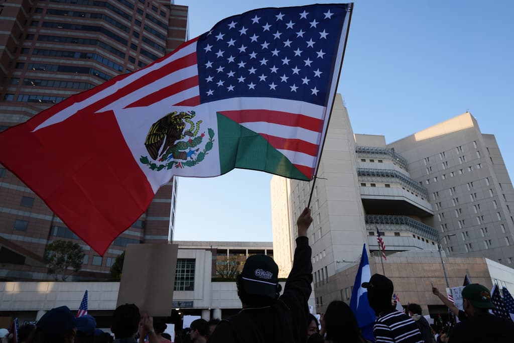 Un manifestante ondea una bandera frente al Centro de Detención Metropolitano de Los Ángeles.