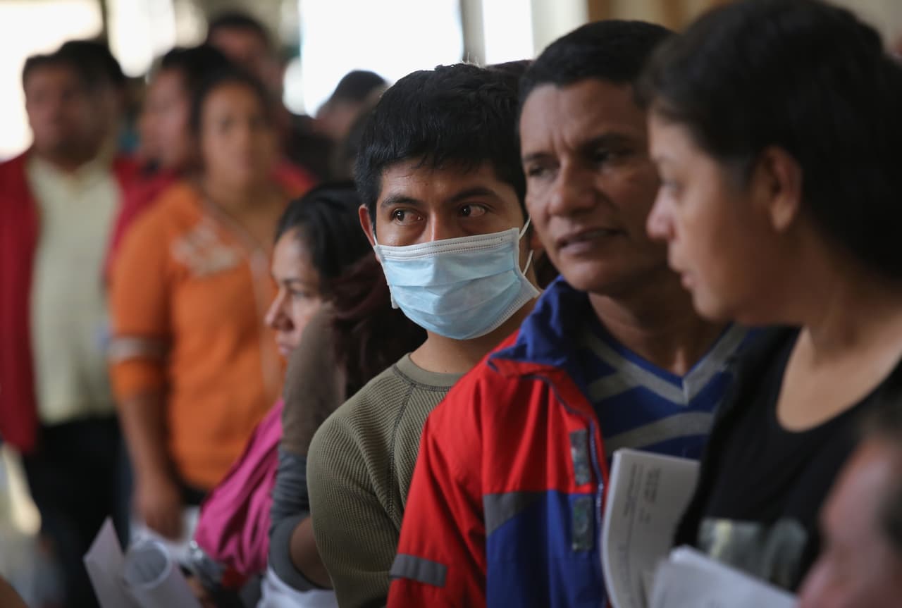 Salvadoran immigrants line up for buses to take them from McAllen, Texas, to other destinations within the United States. Vice President Joe Biden recently defended changes in U.S. policy to facilitate asylum requests made by Central Americans from their home countries.