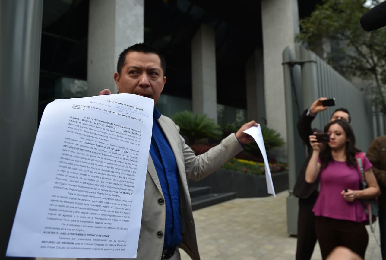 <b>The appeal, November 2016.</b> Joaquín 'El Chapo' Guzmán's lawyer, Andrés Granados, shows documents outside a federal court in Mexico on November 8, 2016 seeking to prevent his clients' extradition to the United States.