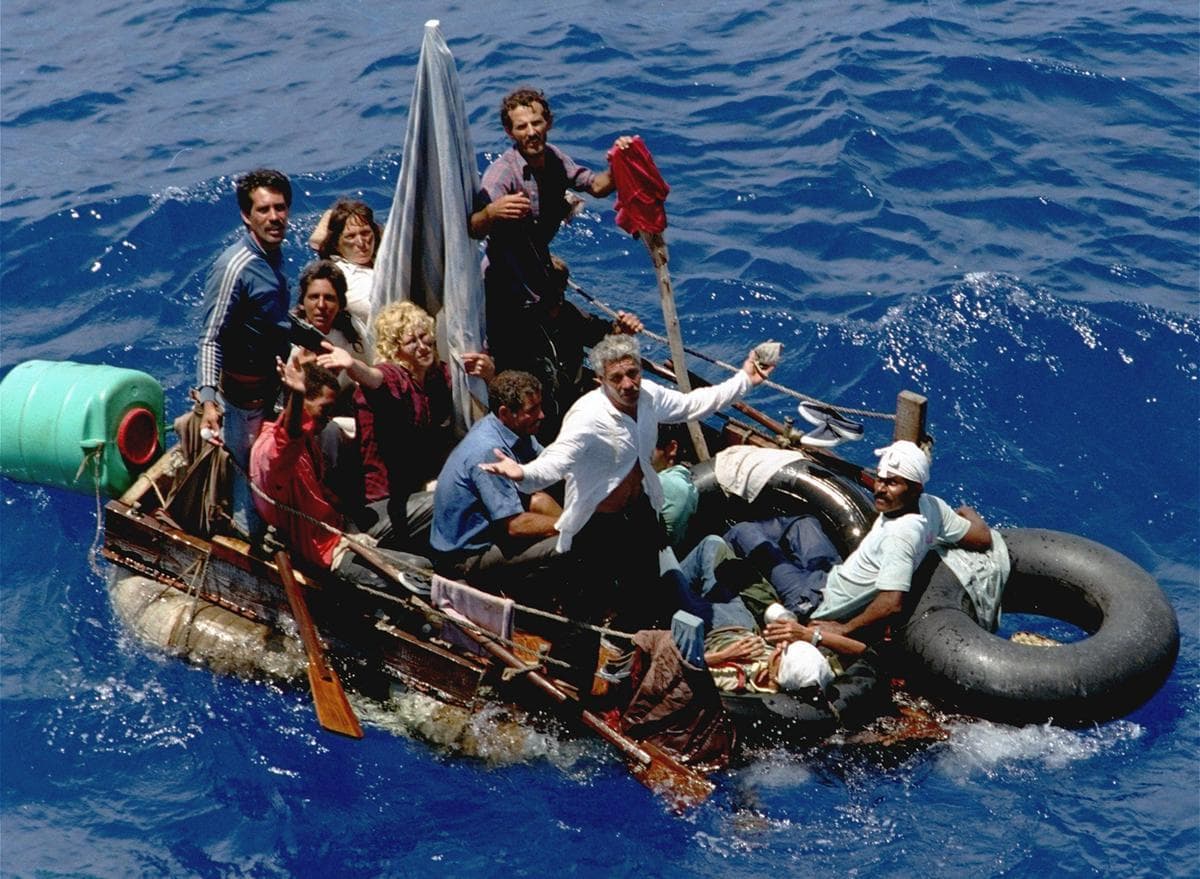 In an August 24, 1994 photo, Cuban refugees stranded on a makeshift raft float in the open sea about halfway between Key West, Florida, and Cuba.