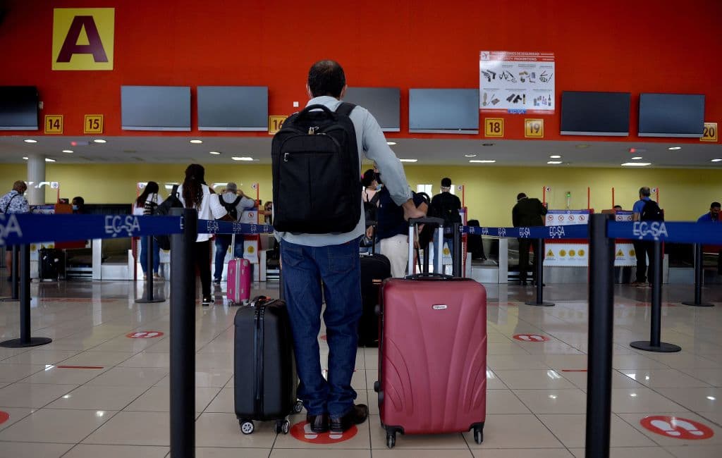 Passengers queue at the Copa Airlines counter at the Jose Marti International Airport as commercial flights resume in Havana on November 15, 2020, after almost eight months amid the new coronavirus pandemic.