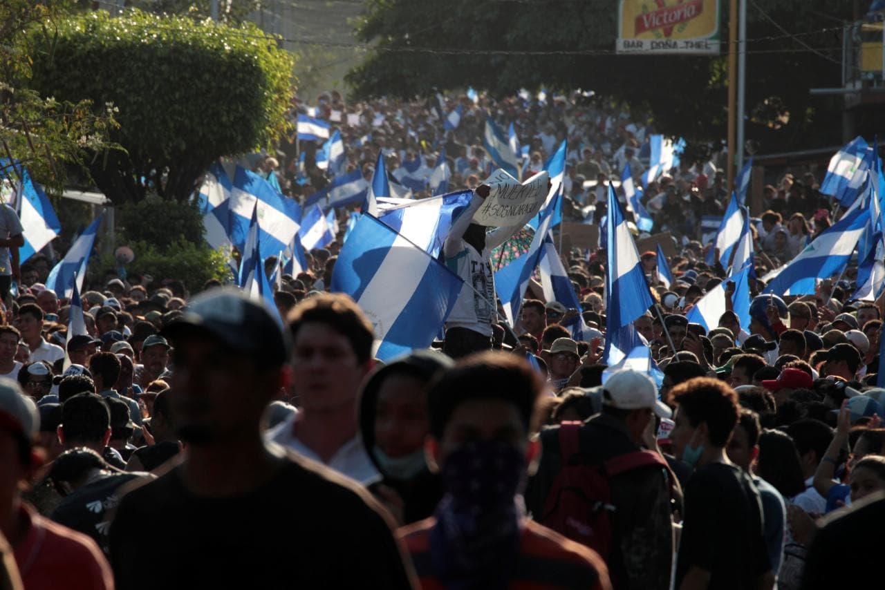 Demonstrators wave flags during a protest against police violence and the government of Nicaraguan President Daniel Ortega in Managua, Nicaragua April 23, 2018.