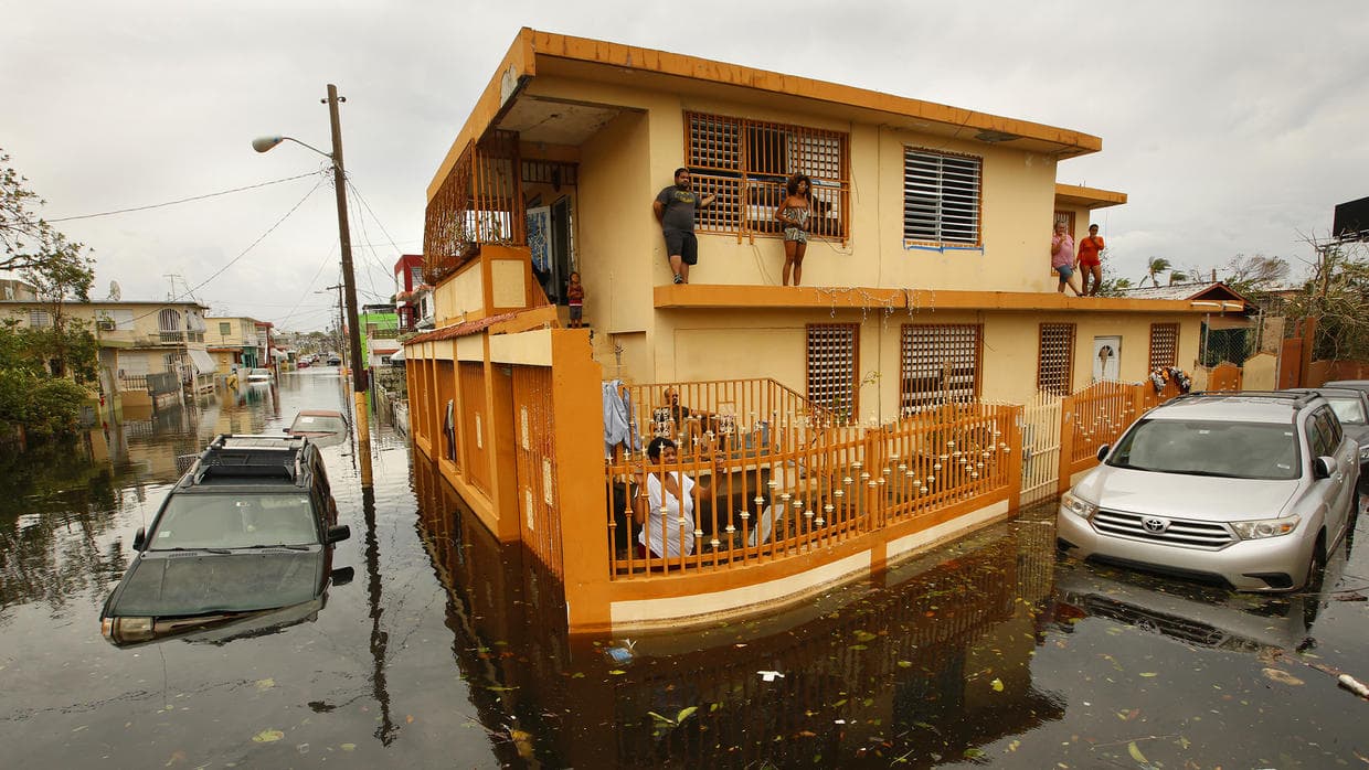 Houses still surrounded by flood water the day after passage of Hurricane Maria. (Getty Images)