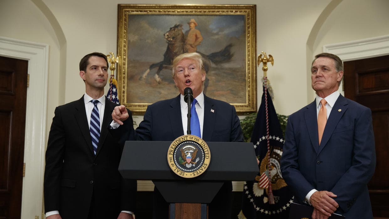 Donald Trump with Republican senators Tom Cotton (pictured left) and David Perdue, who are supporting legislation to impose stricter limits on legal immigration.