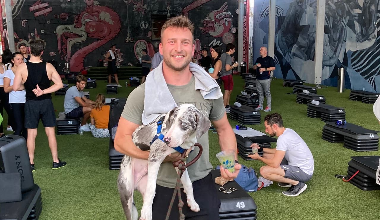Jake Schuster with his dog, Maverick, at Barry's Boot Camp, an open-air gym in the Wynwood district of Miami.