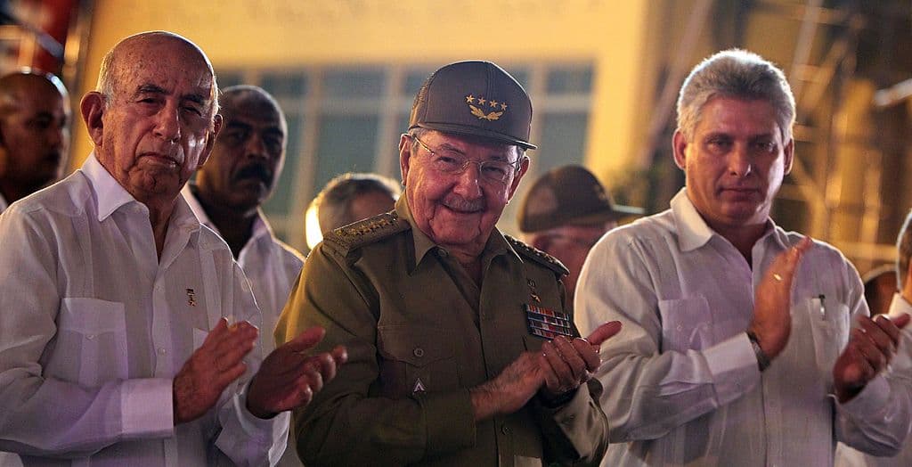 Cuban President Raul Castro (C) participates in a ceremony marking the 55th anniversary of the Cuban Revolution, on January 1, 2014 in Santiago de Cuba, some 900 km southeast of Havana. At left is vice president Jose Ramon Machado Ventura; at right is first vice president Miguel Diaz Canel.