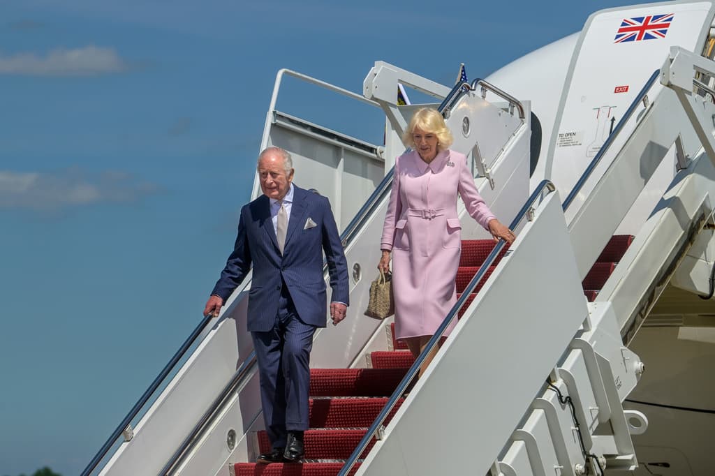 Los reyes Carlos III y Camila llegaron a
<b> la base Andrews, en Maryland</b>. La reina, de 78 años, presumió
<b>un vestido abrigo Dior</b>, una de las casas de diseño preferidas de la primera dama de Estados Unidos, Melania Trump.
<br>
<br>La reina Camila acentuó su look con
<b>un broche Cartier</b> en platino, con
<b>diamantes</b>,
<b>zafiros</b>,
<b>esmeraldas</b> y
<b>rubíes</b>. ¿Por qué es relevante?
<br>
<br>Porque ese broche, que combina las banderas británica y estadounidense, tiene un inmesurable valor histórico: evoca la primera visita de
<b><a href="https://www.univision.com/noticias/mundo/reina-isabel-vida-fotos-fotos" target="_blank">su suegra, la reina Isabel II (1926-2022)</a></b> a Estados Unidos, en el 1957.
<br>
<br>Se lo regaló el entonces
<b>alcalde de la ciudad de Nueva York, Robert Ferdinand Wagner</b> (1910-1991), celebrando los vínculos entre ambas naciones.
