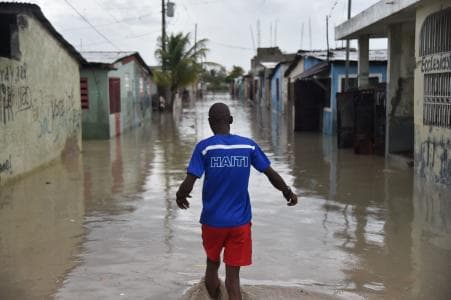 Man walking in Port-au-Prince slum, Cite Soleil, after Hurricane Matthew
