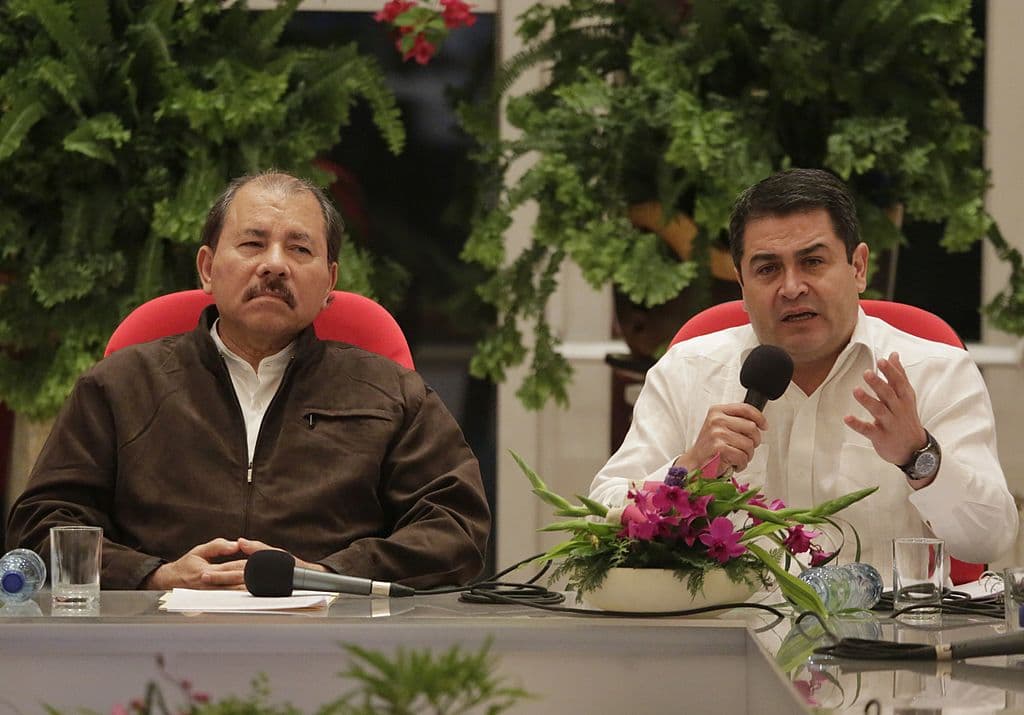 President of Nicaragua, Daniel Ortega (L) listens to President of Honduras, Juan Orlando Hernandez (R) gives a speech.