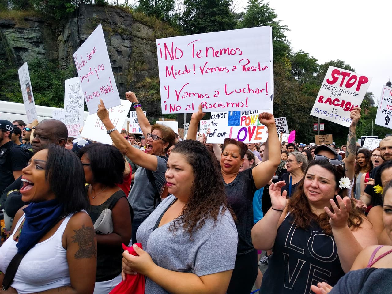 <b>"We're not scared, we're going to resist, we're going to fight!" </b>At left, Dominican Ana Victoria protests against hate.
