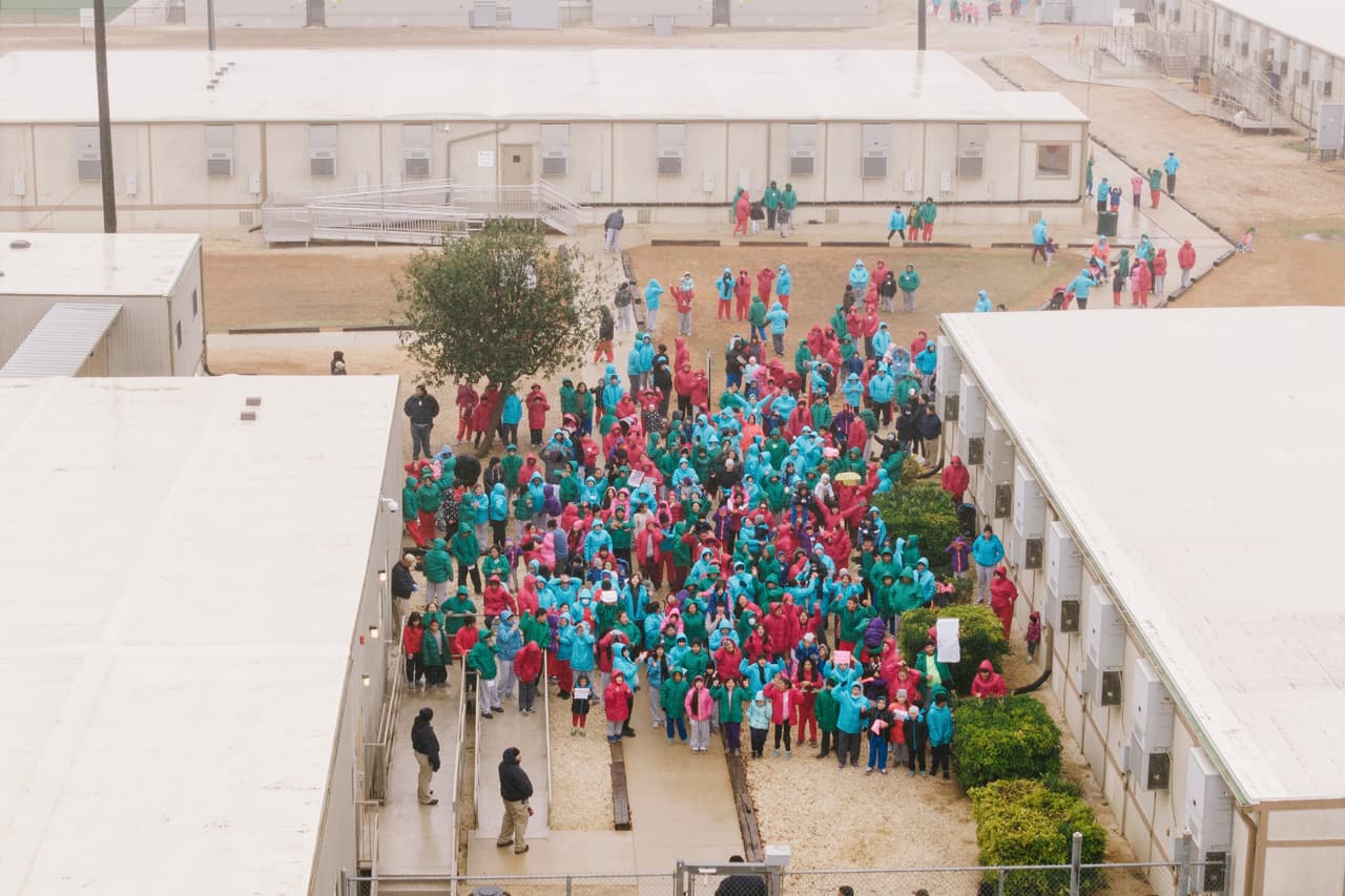 FILE - Detainees held at the South Texas Family Residential Center wave signs during a demonstration in Dilley, Texas, Saturday, Jan. 24, 2026. (AP Photo/Brenda Bazán, File)